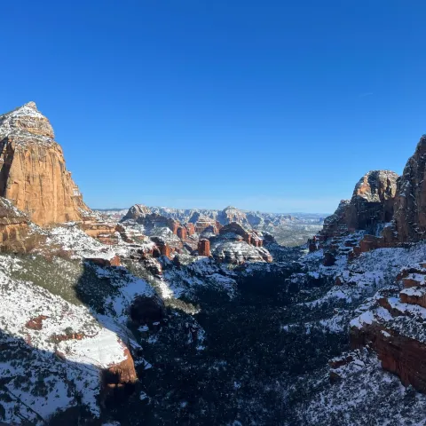 a canyon with a mountain in the snow