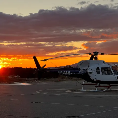 a plane on the tarmac at sunset