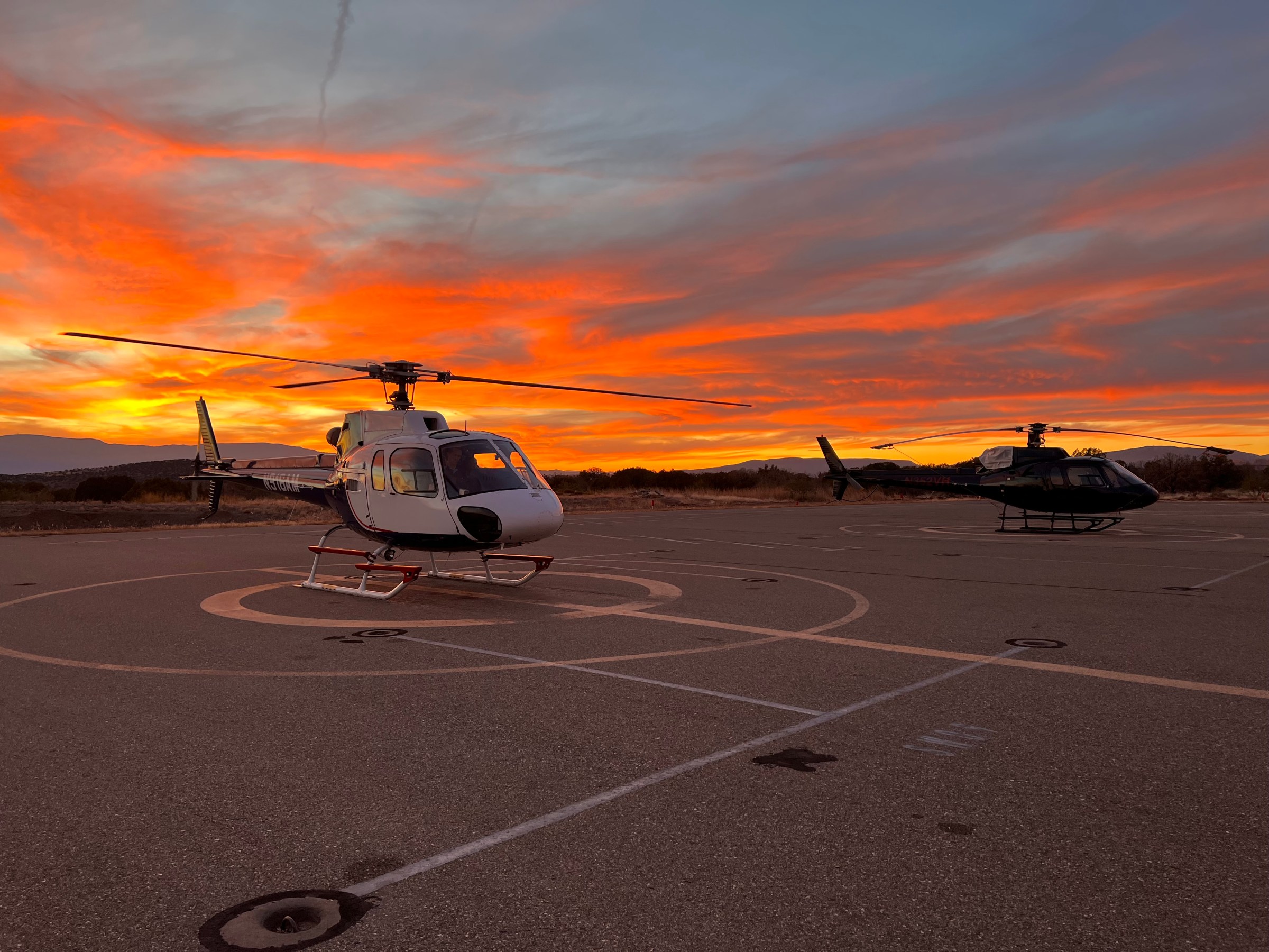 APEX AIR TOURS HELICOPTER AT THE SEDONA AIRPORT DURING SUNSET TIME