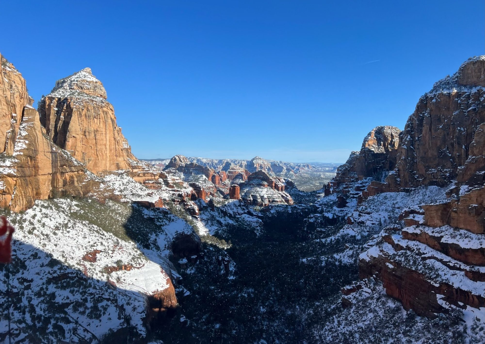 a canyon with a mountain in the snow