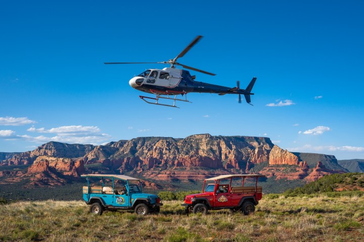 a helicopter flying over a mountain